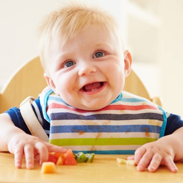 Baby,Boy,Eating,Fruit,In,High,Chair