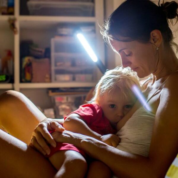 Mother,,Breastfeeding,Her,Toddler,Boy,At,Home,At,Night,,Night